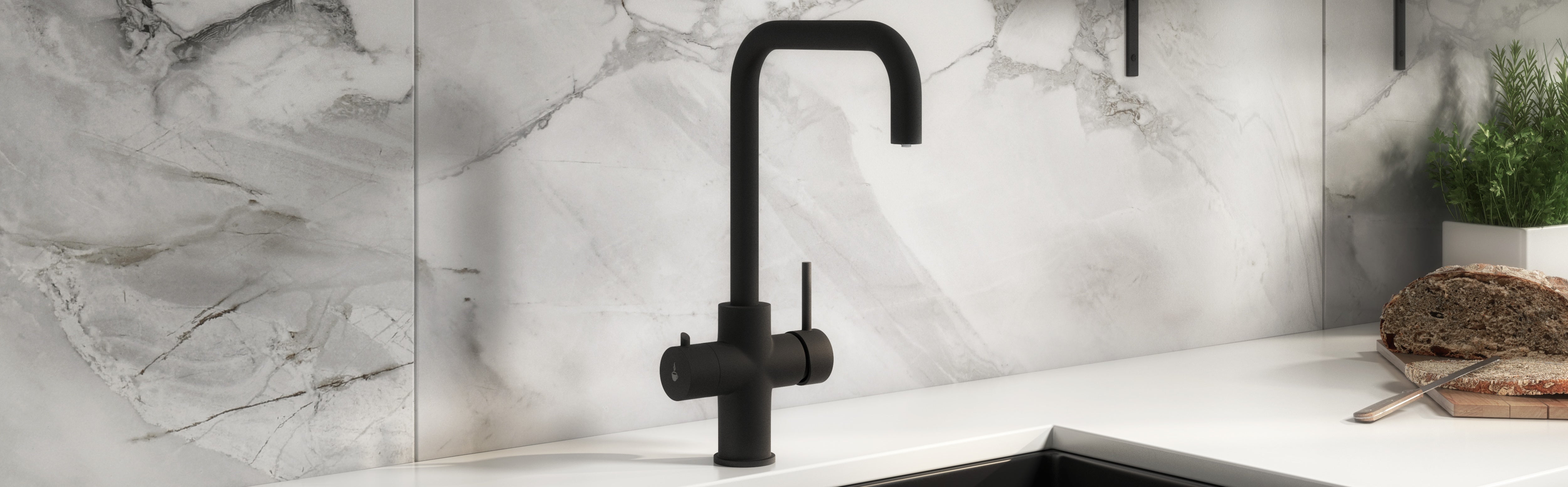 Matt black boiling water tap on a marble backsplash