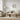 Round wall mirror with a black frame in a minimal cosy UK living room