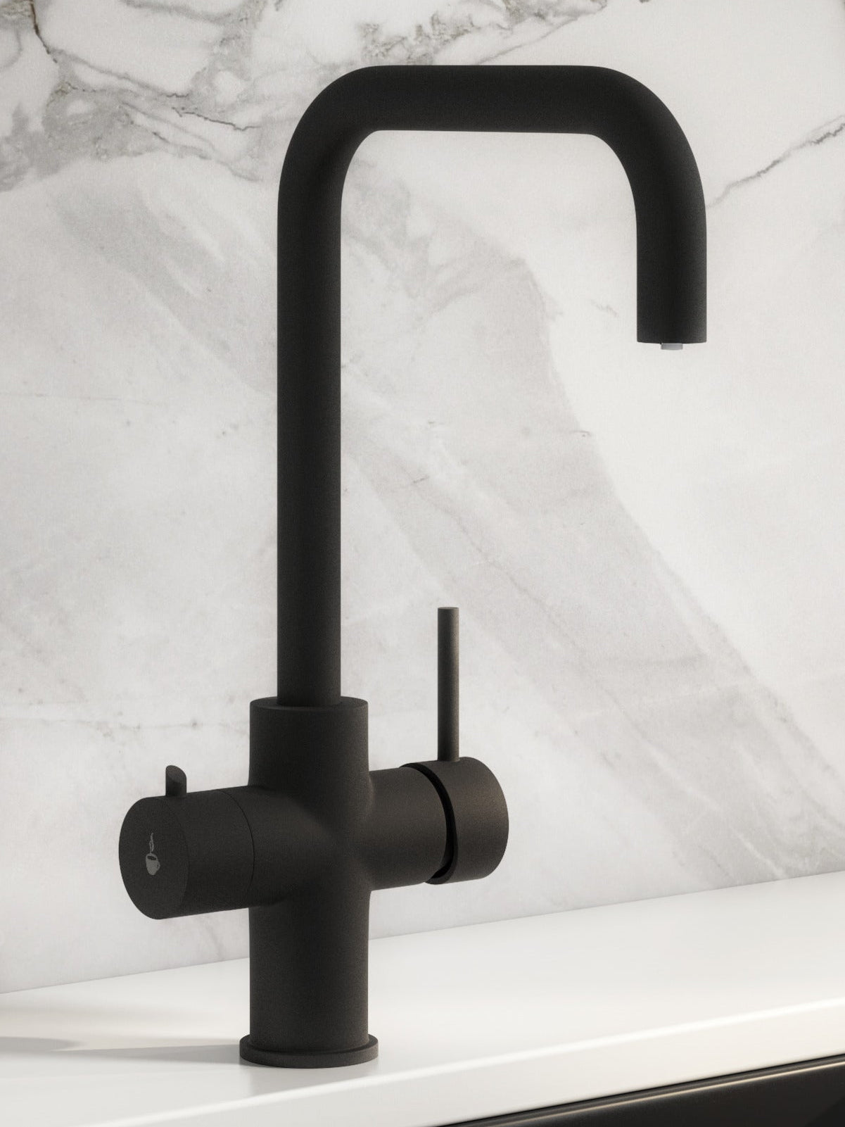 Modern matt black boiling water tap with marble backsplash and white countertops.
