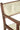Close up of a Dining Chair with teak wooden frame and cream leather upholstery on a white background