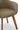 Brown upholstered chair with wooden legs on a light wooden floor.