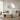 Modern living room with a beige sofa, wooden coffee table, and decorative mirror.
